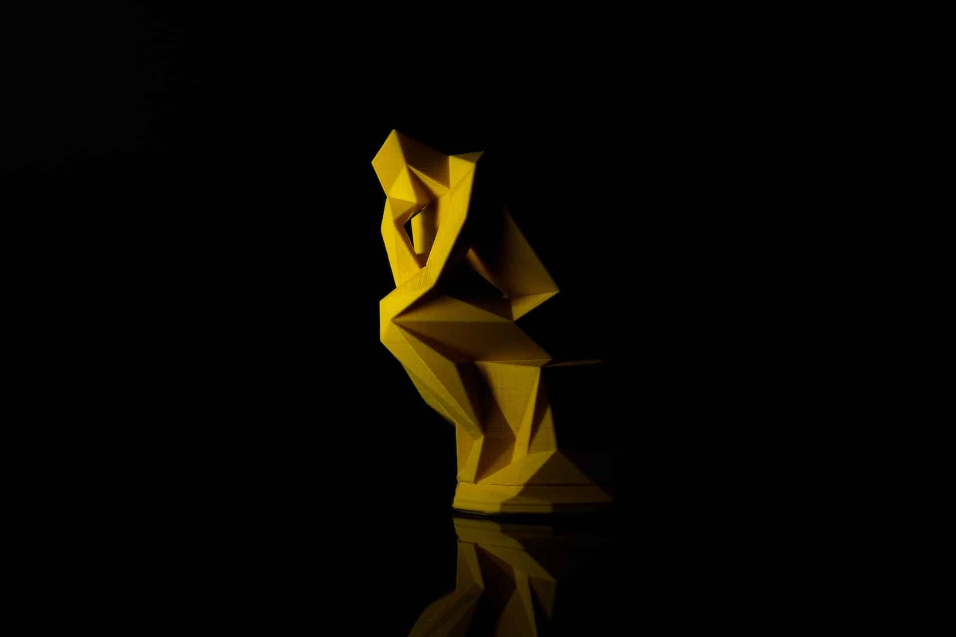 Photo by Vinicius "amnx" Amano on Unsplash of anstract version of Rodin's The Thinker